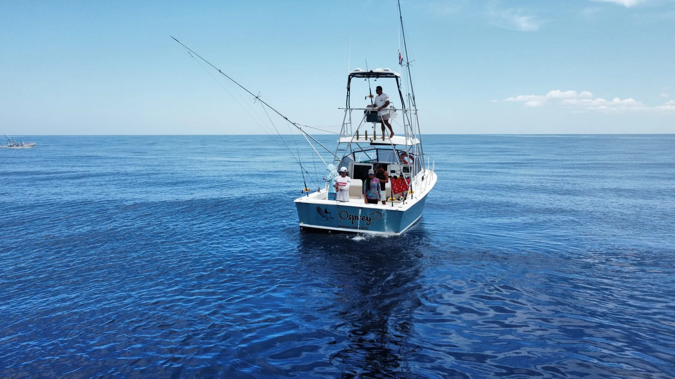 The Osprey with guests fishing, name on the transom