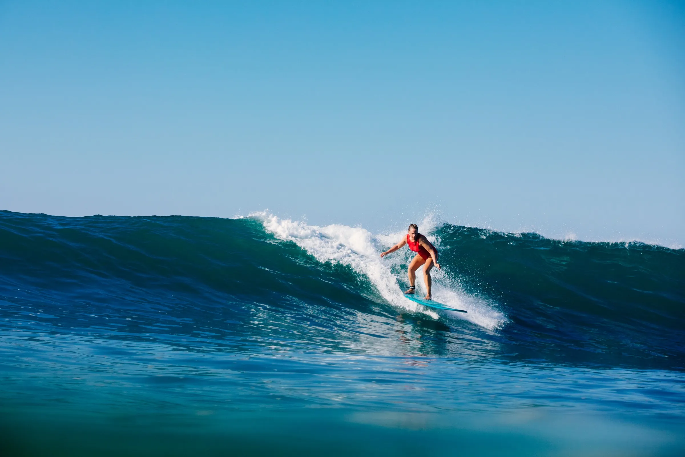 A surfer riding a wave off Playa Garza, Nosara