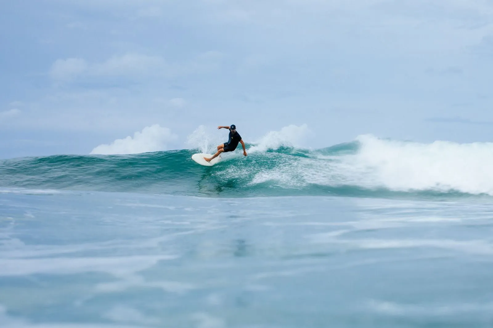 A surfer on a wave off the Nosara coast